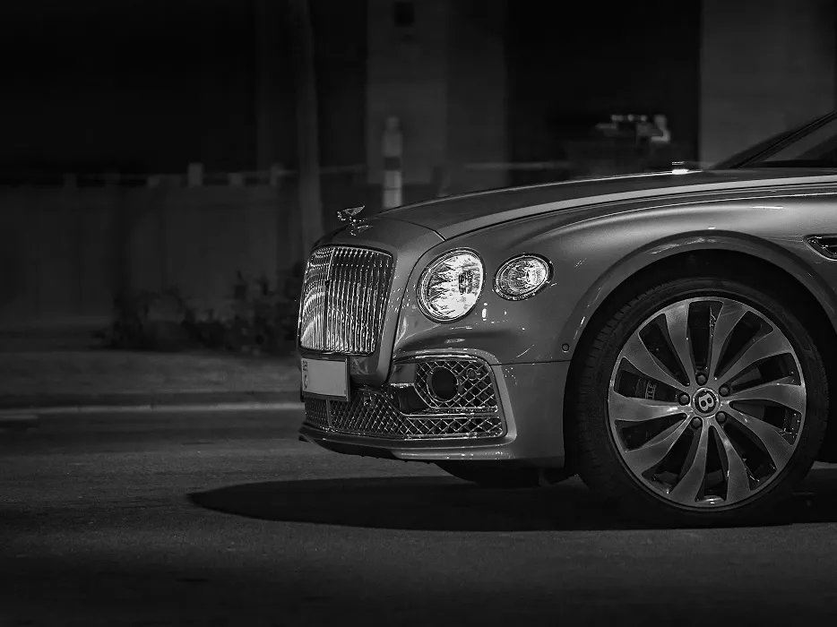 夜の街路に停車する高級車のフロントマスク